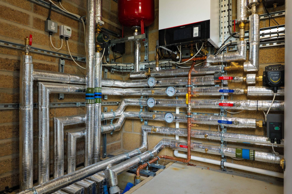 Heat pump plant room with insulated pipework at the Boxworth home