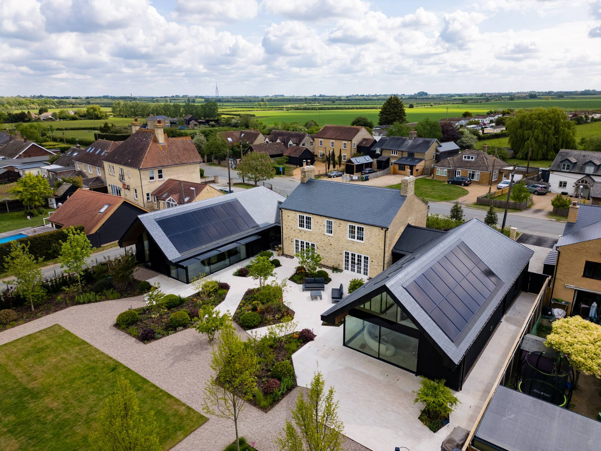 Aerial view of a renovated Boxworth home with in-roof solar panels
