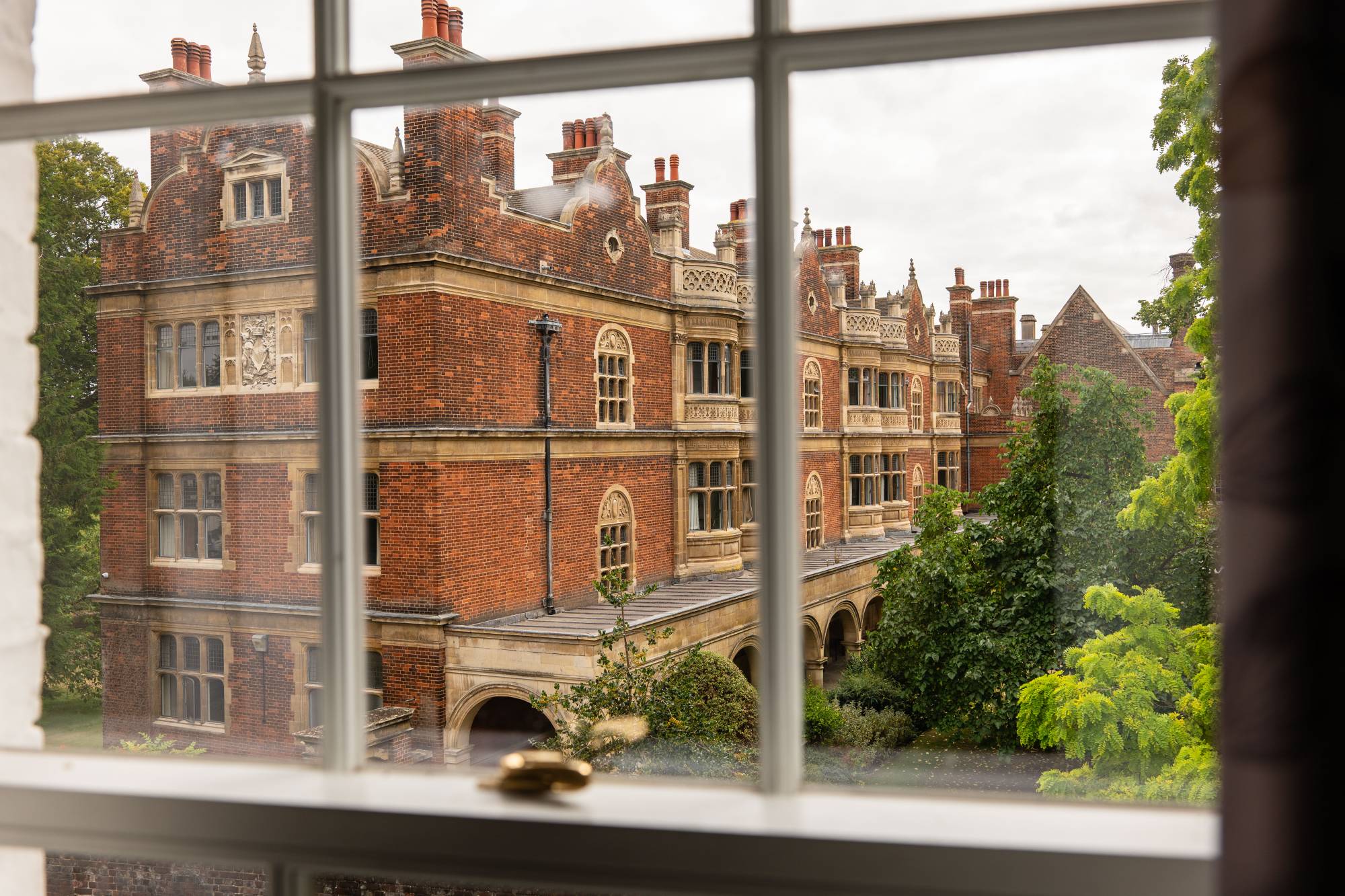 Historic college student accommodation in Cambridge, seen through a sash window