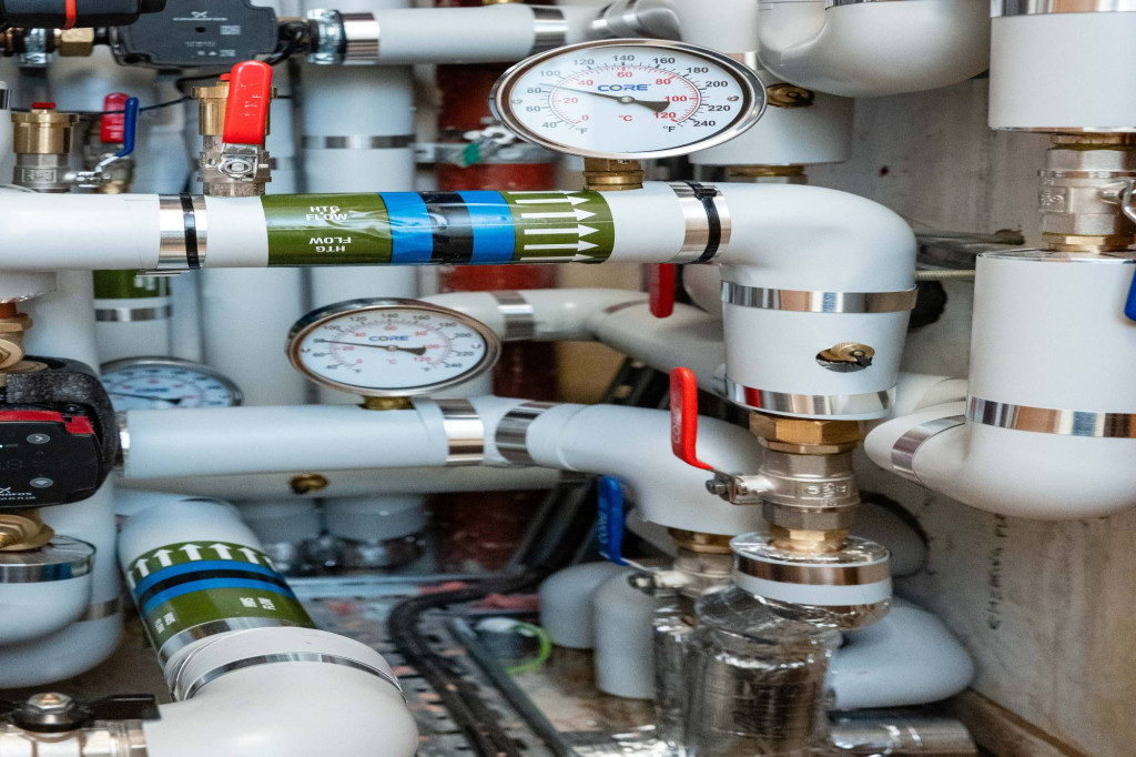 Heat pump pipework with pressure gauges in the Estates office plant room