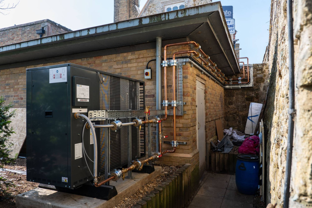 Air source heat pump installed beside the historic restaurant building