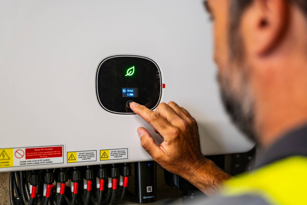 Engineer checking the solar inverter display at Millworks Timber