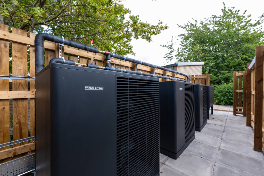 Row of Stiebel Eltron air source heat pumps in the plant compound at a Cambridge nursery