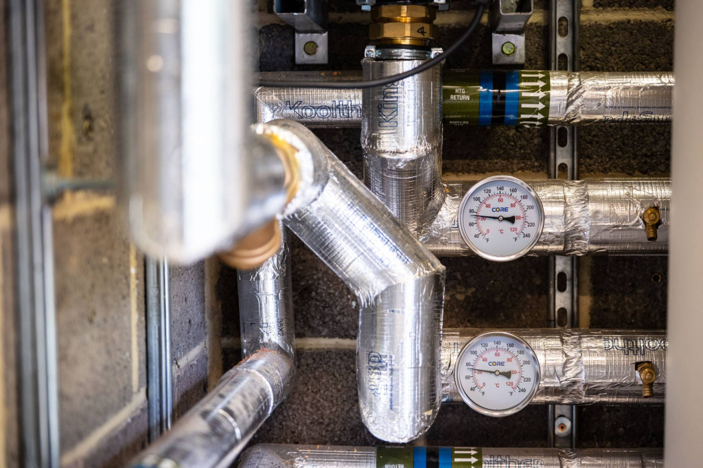 Insulated pipework and temperature gauges in the nursery plant room