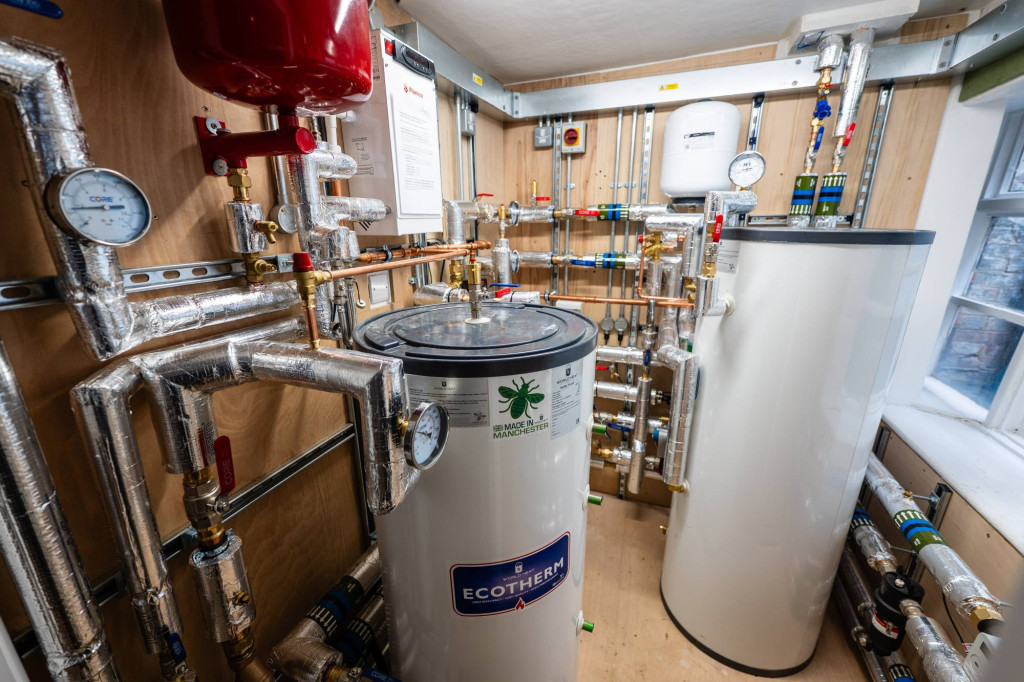 Hot water cylinders and pipework in a Cambridge student accommodation plant room